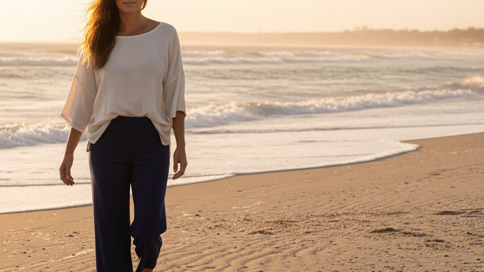 Photoreal wide 16:9 hero image of a women model wearing Athleta Brooklyn Wide Leg Crop Pant.