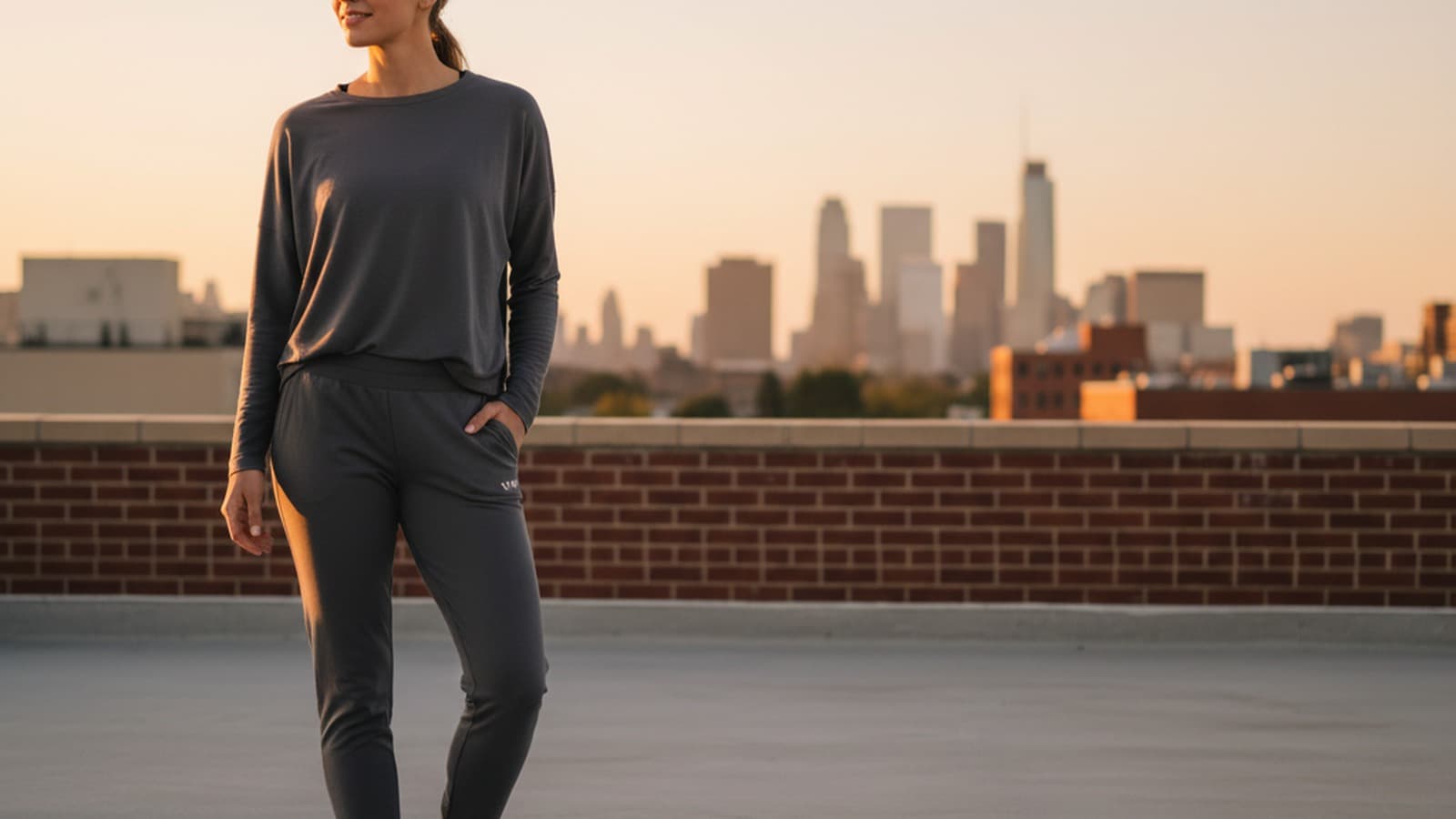 Photoreal wide 16:9 hero image of a women model wearing Vuori Women's Performance Jogger.